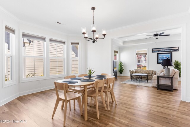 4067 Reunion Pointe Ln, New Bern, NC 28562 - dining space with light wood finished floors, plenty of natural light, a chandelier, crown molding, and baseboards