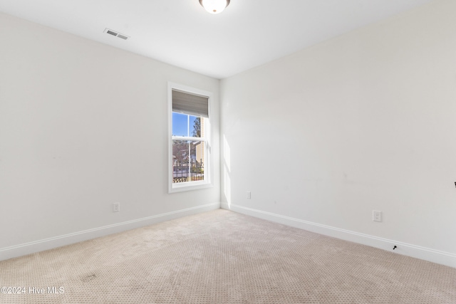 spare room with light colored carpet