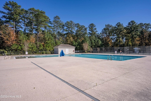 4067 Reunion Pointe Ln, New Bern, NC 28562 - community pool with a patio and view of scattered trees