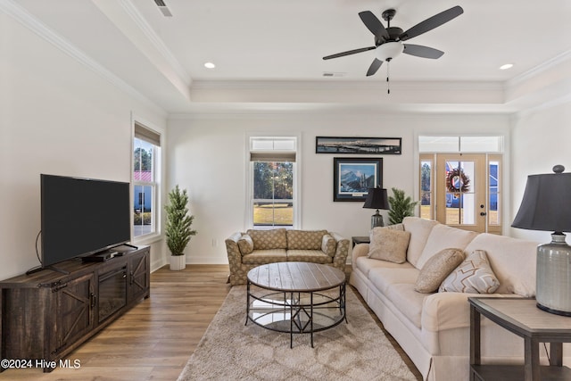 4067 Reunion Pointe Ln, New Bern, NC 28562 - living area featuring a tray ceiling, light wood finished floors, crown molding, ceiling fan, and baseboards