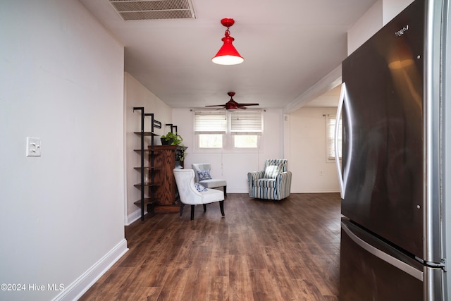 living area with ceiling fan and dark hardwood / wood-style flooring