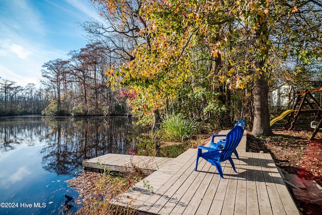 dock area featuring a playground and a water view