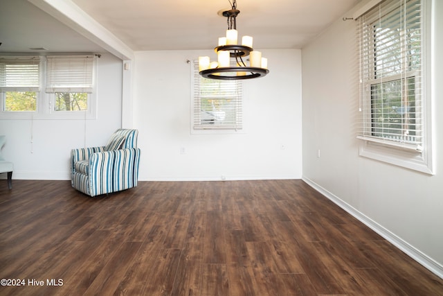 unfurnished room with dark hardwood / wood-style flooring and a chandelier