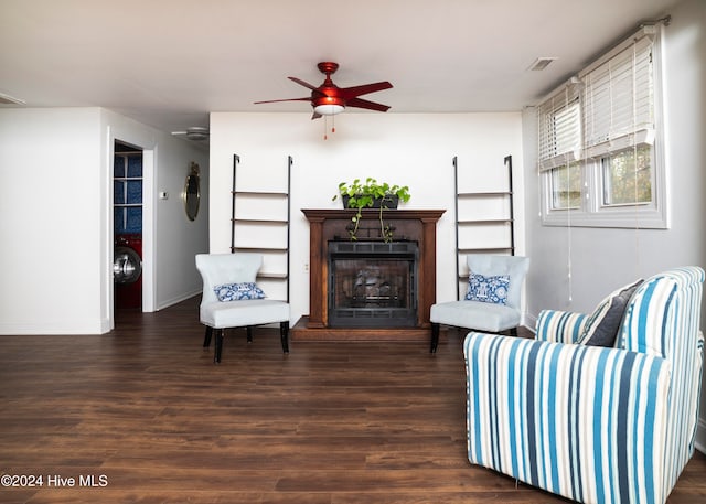 sitting room with ceiling fan and dark hardwood / wood-style floors