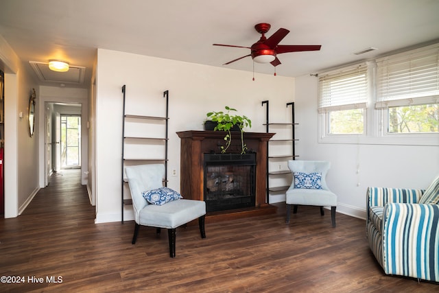 sitting room with dark hardwood / wood-style floors, a healthy amount of sunlight, and ceiling fan