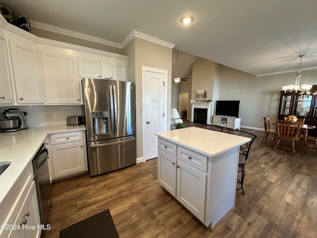 kitchen with decorative light fixtures, stainless steel appliances, white cabinetry, and dark hardwood / wood-style floors