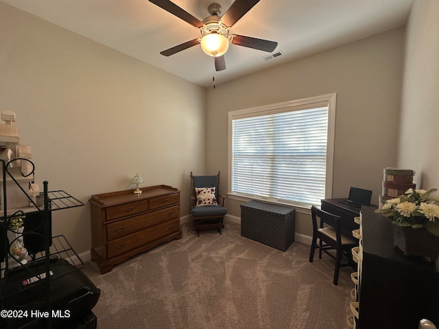 living area featuring carpet flooring and ceiling fan