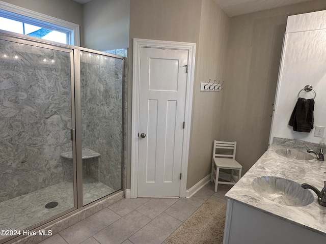 bathroom with tile patterned flooring, vanity, and an enclosed shower