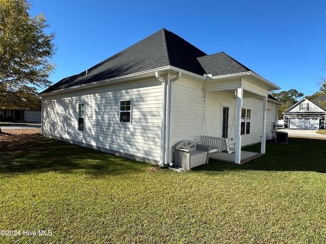 view of property exterior with central air condition unit and a yard