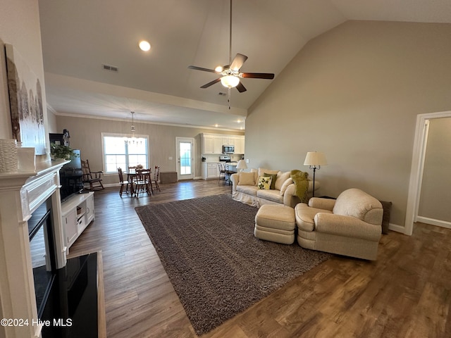 living room with ceiling fan, lofted ceiling, and dark wood-type flooring