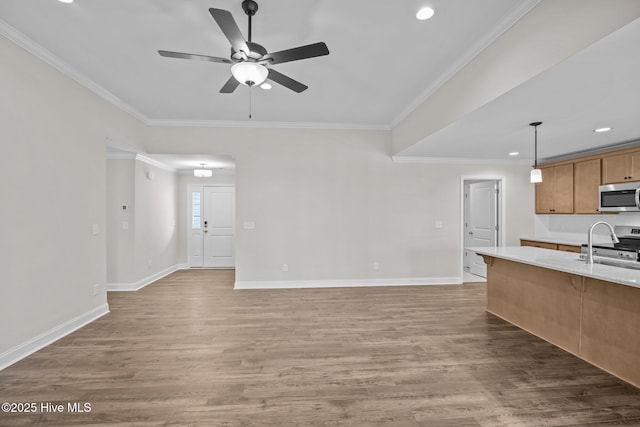 kitchen with appliances with stainless steel finishes, crown molding, dark hardwood / wood-style flooring, and pendant lighting