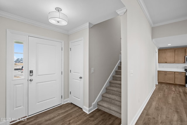 foyer with dark hardwood / wood-style flooring and ornamental molding