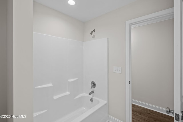 bathroom featuring hardwood / wood-style flooring and shower / tub combination