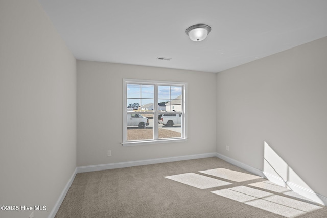 unfurnished room with light colored carpet