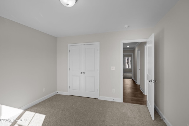 unfurnished bedroom with a closet and carpet floors