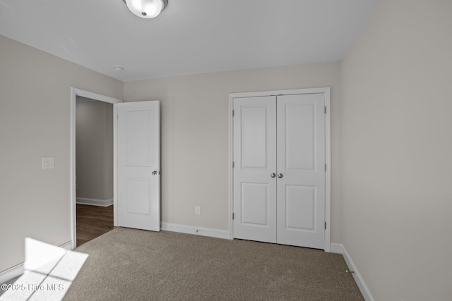 unfurnished bedroom featuring carpet and a closet