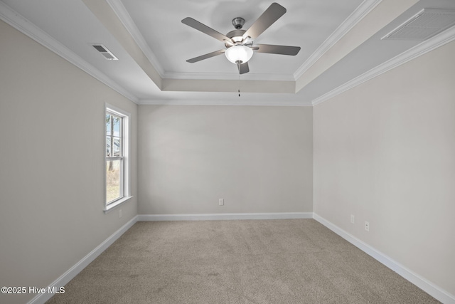 carpeted empty room featuring a raised ceiling, ceiling fan, and ornamental molding