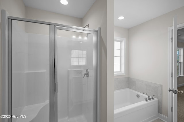 bathroom with shower with separate bathtub