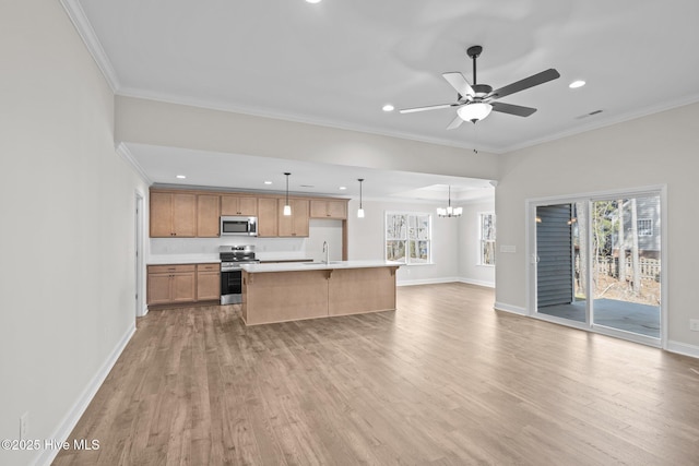 kitchen featuring hanging light fixtures, stainless steel appliances, a kitchen island, light hardwood / wood-style floors, and sink