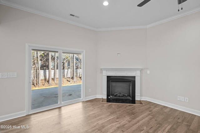 unfurnished living room featuring ceiling fan, crown molding, and wood-type flooring