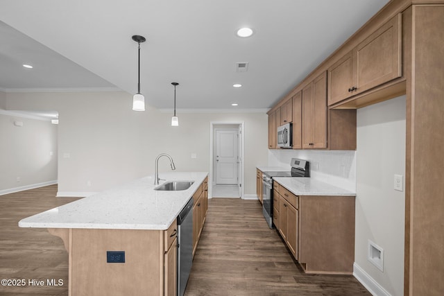 kitchen with sink, decorative light fixtures, stainless steel appliances, an island with sink, and light stone countertops