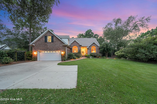 view of front of home with a front yard and a garage