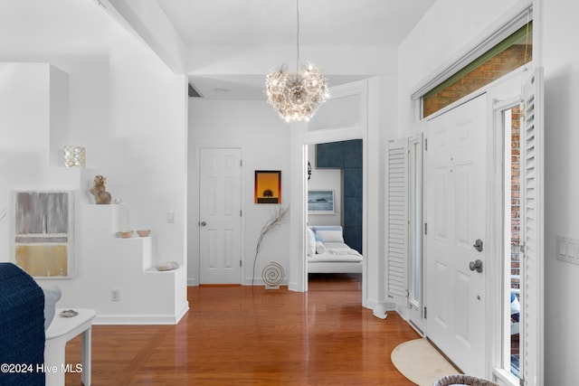 entryway with a chandelier and dark hardwood / wood-style floors