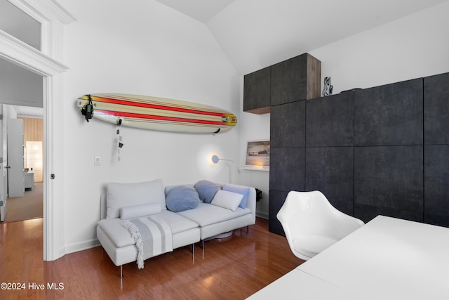 bedroom with dark hardwood / wood-style flooring and vaulted ceiling