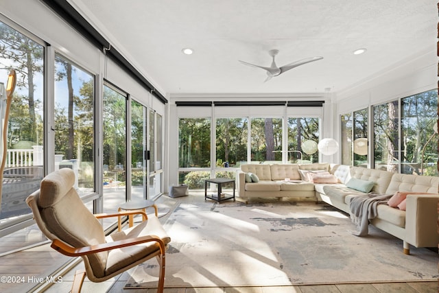 sunroom with plenty of natural light and ceiling fan