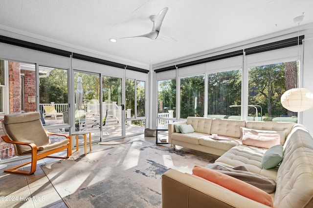 sunroom with ceiling fan and a healthy amount of sunlight