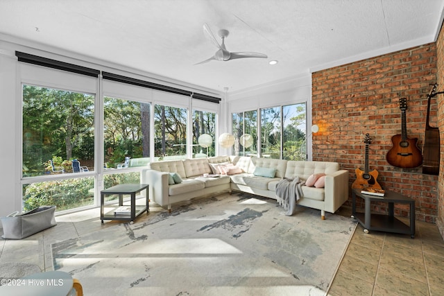 unfurnished sunroom featuring ceiling fan