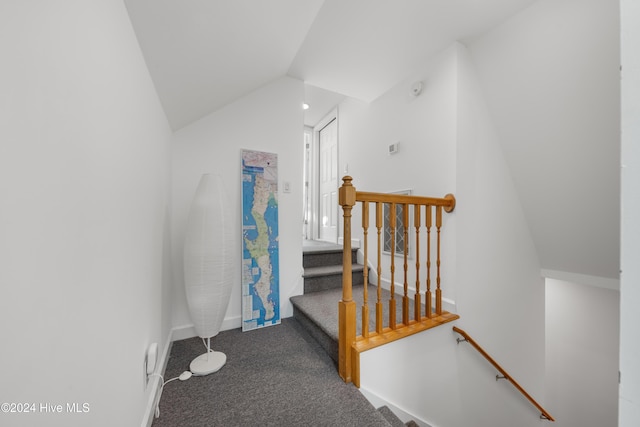 carpeted office space with vaulted ceiling