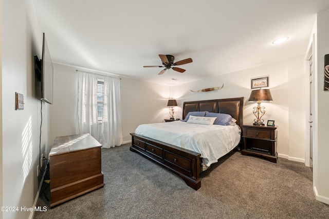 bedroom with ceiling fan and dark colored carpet