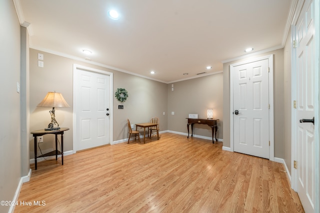 living area featuring light hardwood / wood-style floors and crown molding