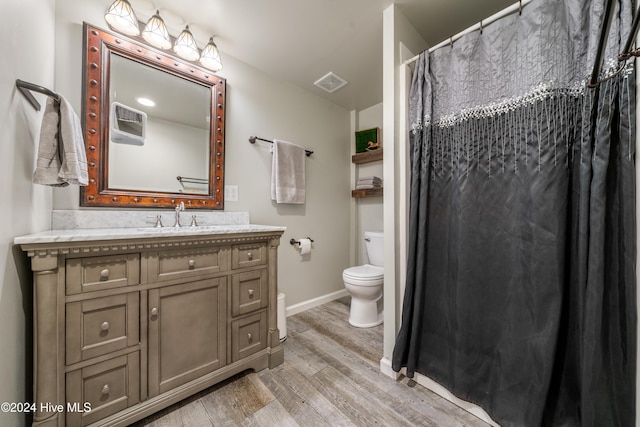 bathroom featuring hardwood / wood-style floors, vanity, and toilet