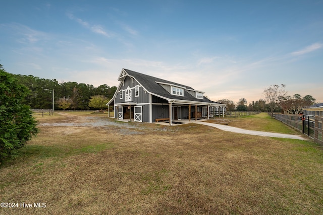 exterior space featuring an outbuilding and a lawn