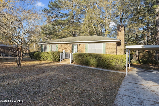 view of front of property featuring a carport