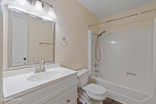 full bathroom featuring a textured ceiling, vanity, bathtub / shower combination, and toilet