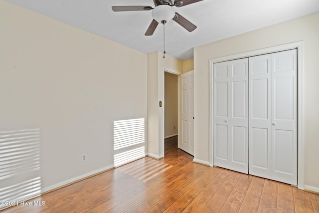 unfurnished bedroom with ceiling fan, a closet, and light hardwood / wood-style floors