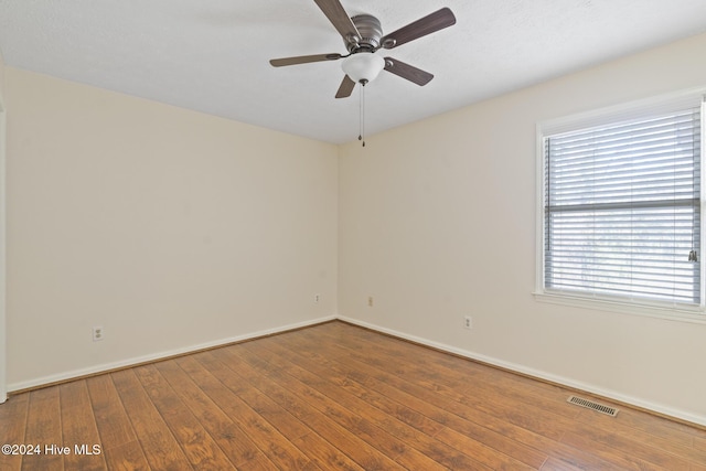 spare room with ceiling fan and hardwood / wood-style flooring