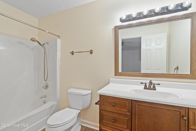 full bathroom featuring vanity,  shower combination, ceiling fan, toilet, and a textured ceiling