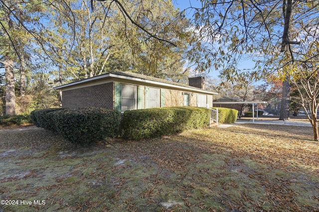 view of home's exterior with a carport