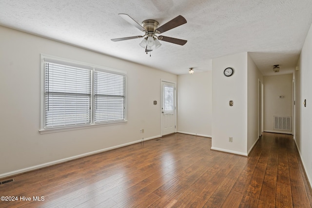 interior space featuring a textured ceiling, dark hardwood / wood-style flooring, and ceiling fan