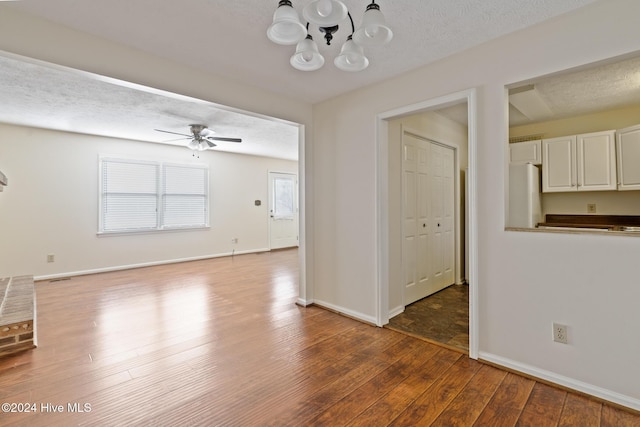 interior space with ceiling fan, hardwood / wood-style floors, and a textured ceiling