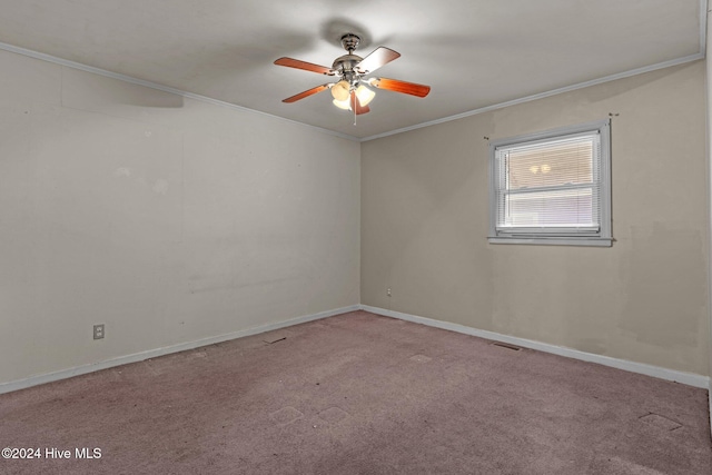 carpeted empty room with ceiling fan and crown molding