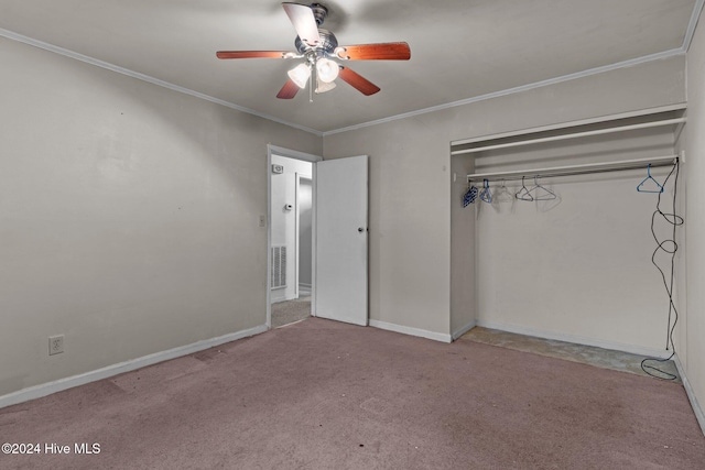 unfurnished bedroom with ceiling fan, crown molding, light carpet, and a closet