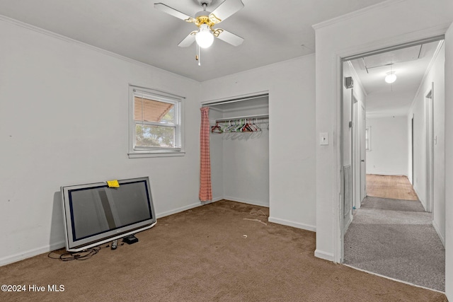 unfurnished bedroom featuring ceiling fan, ornamental molding, light carpet, and a closet