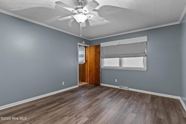 empty room featuring hardwood / wood-style floors, ceiling fan, and ornamental molding