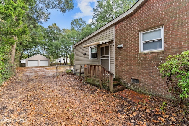 view of side of home featuring an outdoor structure and a garage