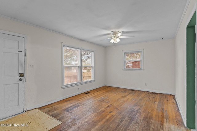 entrance foyer featuring hardwood / wood-style flooring, ceiling fan, and crown molding